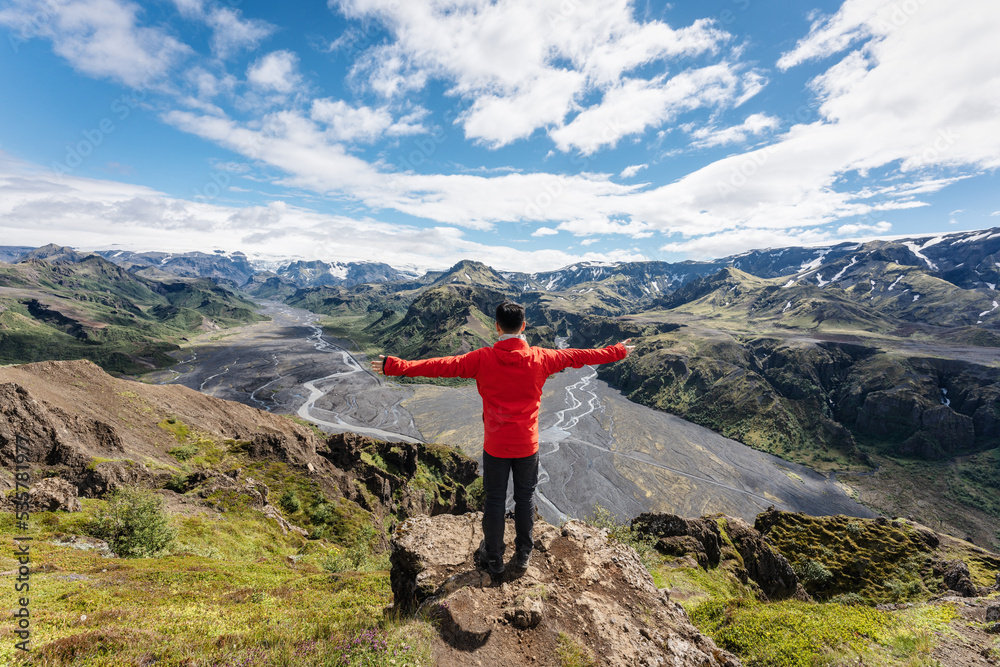 Male hiker standing with cheerful on top of mountain in Valahnukur viewpoint