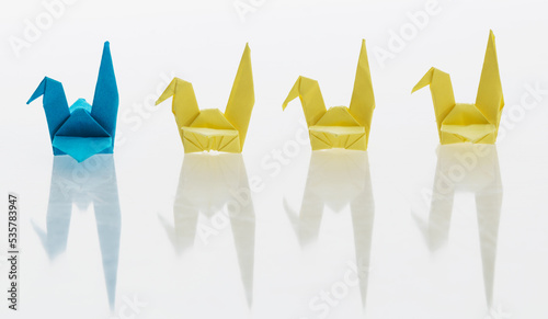 A row of paper cranes on white background