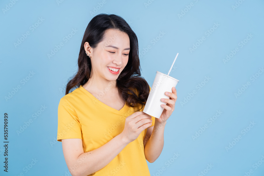 Image of young Asian woman holding a cup of bubble tea Image of young Asian woman holding a cup of bubble tea