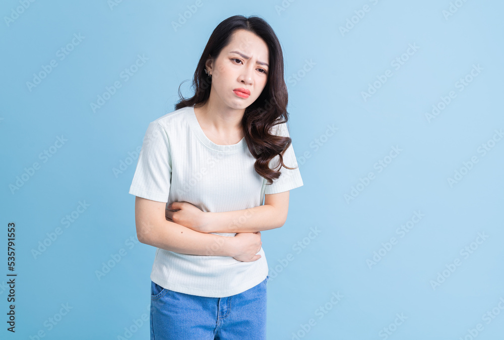 Young Asian woman with stomachache. Young Asian woman with stomachache.