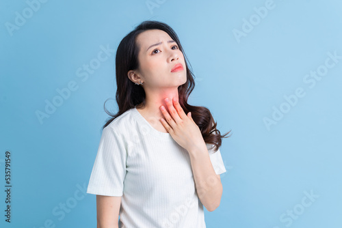 Young Asian woman has a sore throat. photo