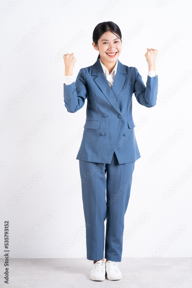 Full length photo of young Asian business woman on background