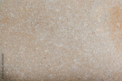 Marble of light orange color in white speckles