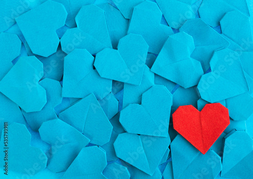 Red origami heart on blue origami hearts