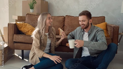 Couple Eating Sandwiches and Drinking Tea from Cups. Couple in new Home Having Dinner. Fast Food Eating at Home. Shot on RED