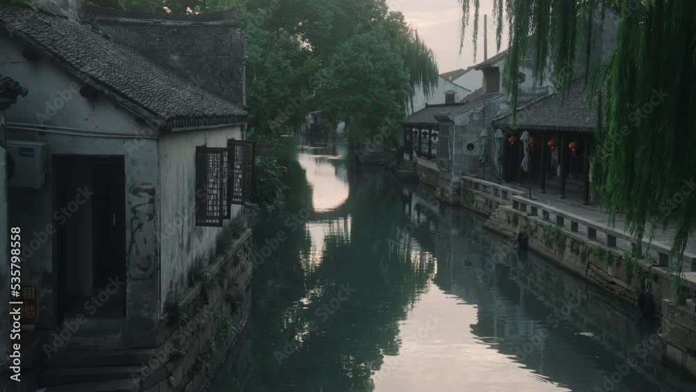 Quiet neighborhood in typical Chinese village, houses on banks of water channel. Static Quiet neighborhood in typical Chinese village, houses on banks of water channel. Static