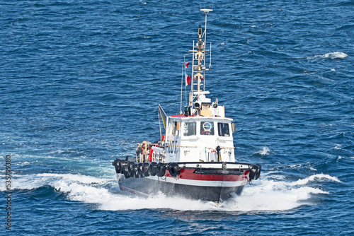 A pilot boat comes out to meet a cruise ship at the entry to the port of St. Johns in Newfoundland, Canada.