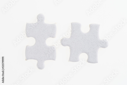 Two puzzle pieces on white background