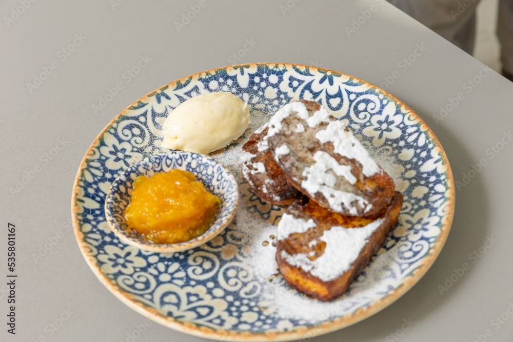 French toast served with peach jam and sugar French toast served with peach jam and sugar