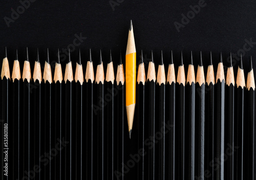 One short pencil in the middle of crowd