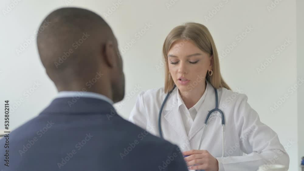 Close Up of Female Doctor Consulting Black African Man Close Up of Female Doctor Consulting Black African Man