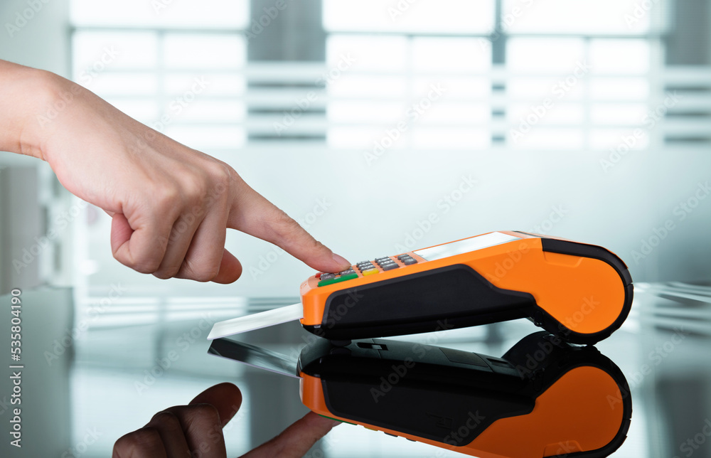 Close up of hand paying with credit card