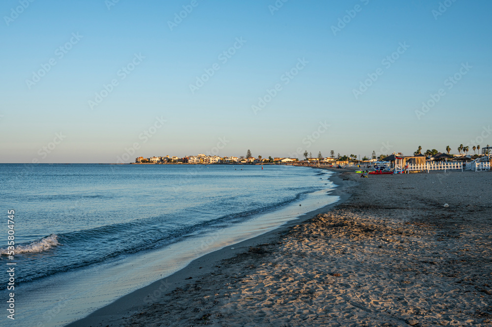The most beautiful beach in Marzamemi with the city in the background