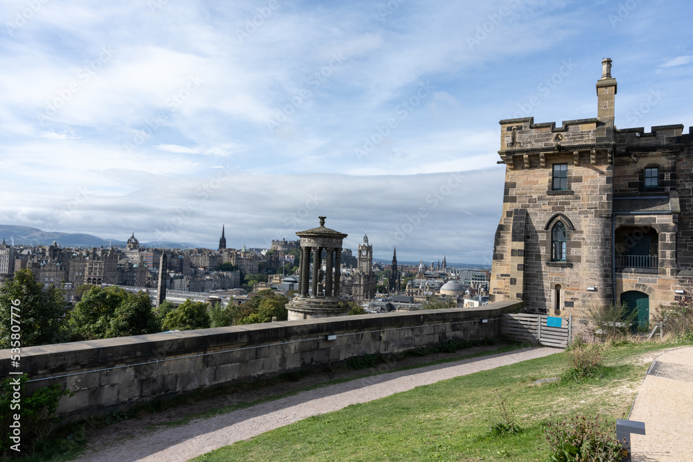 Calton hill with neoclassical monuments and striking view of the urban skyline