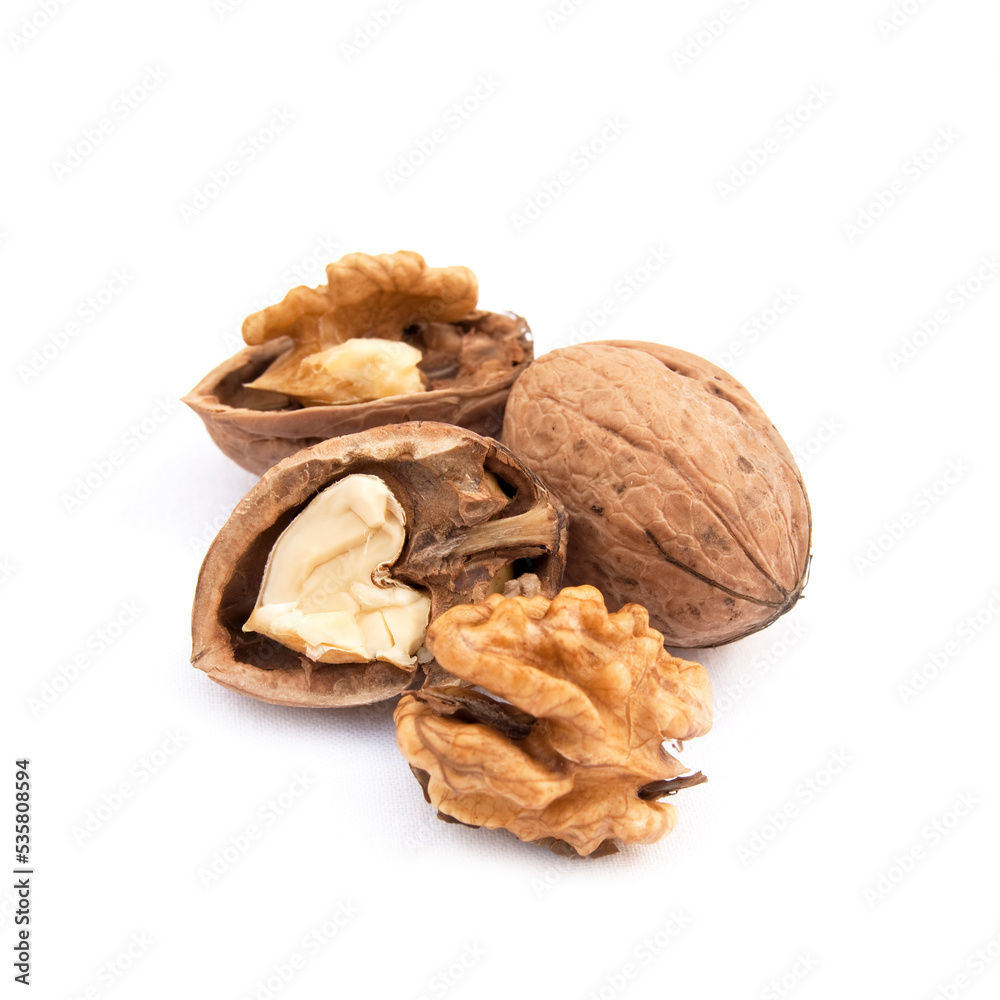 Walnut and split walnut with kernel inside on the white background Walnut and split walnut with kernel inside on the white background