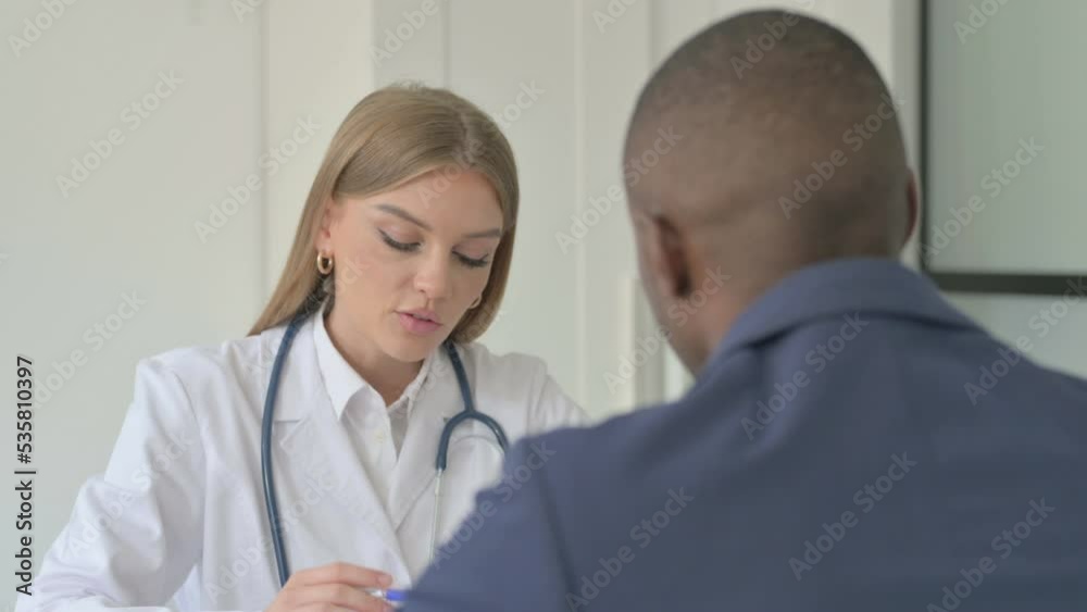 Female Doctor Talking with African Man Patient Female Doctor Talking with African Man Patient