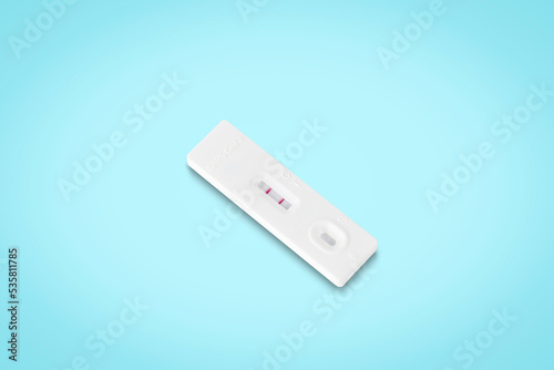 covid-19 positive test result. antigen (ATK) test kit​ isolated on​ light blue​ background with clipping path. top view. flat lay.