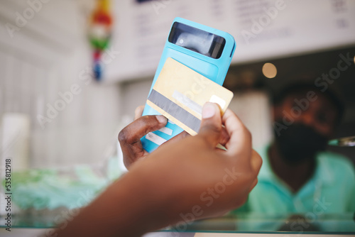 Customer hand payment using credit card, machine and 5g technology. Manager or cashier transacting with internet and nfc to tap or scan for the bill at grocery store contactless checkout point photo