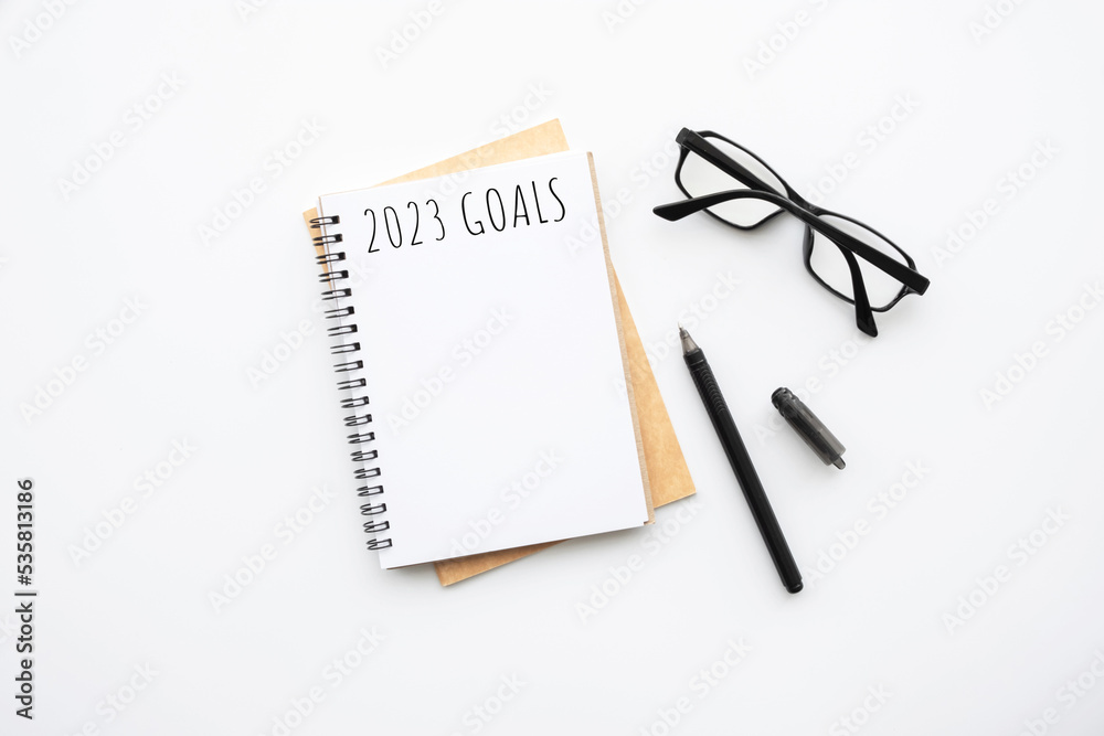 Notebook with 2023 goals text on it to apply new year resolutions and plan. Notebook with 2023 goals text on it to apply new year resolutions and plan.