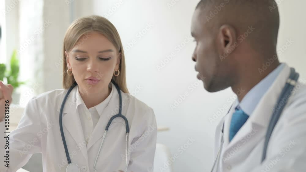 Close up of Female Doctor Talking with African Doctor Close up of Female Doctor Talking with African Doctor
