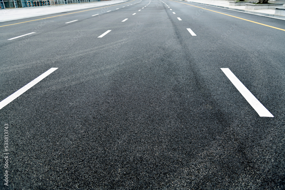 Asphalt road with white dashed lines