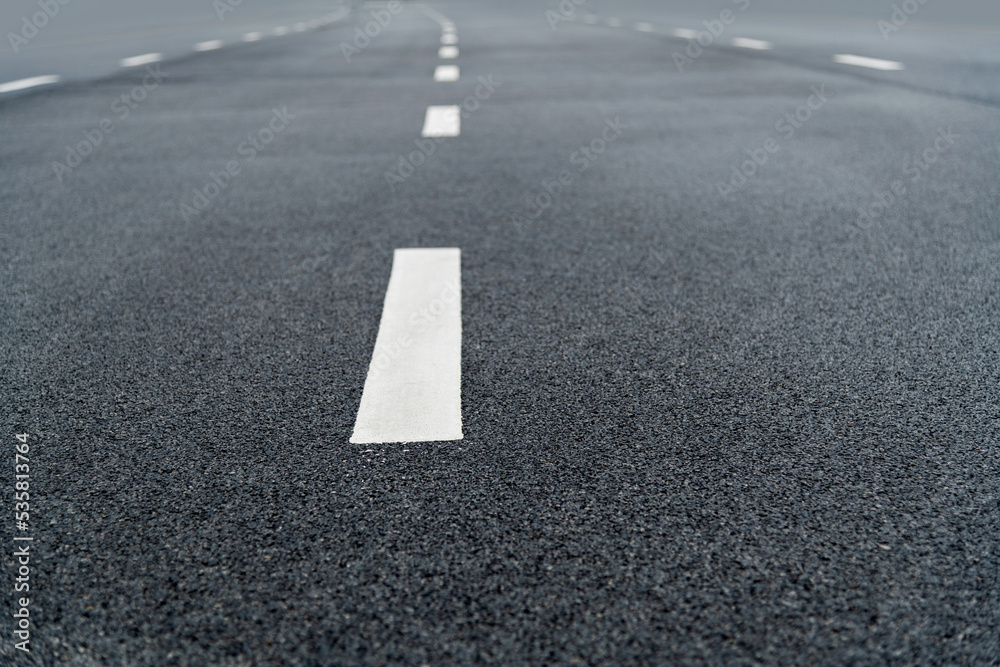 Asphalt road with white dashed lines Asphalt road with white dashed lines