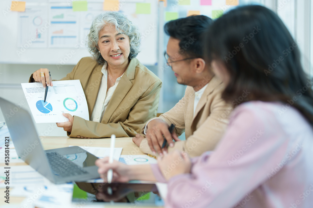 Fototapeta premium Asian entrepreneurs and business people meeting in a conference room in business planning, financial budget and investment risk assessment to analyze customer groups to increase company growth