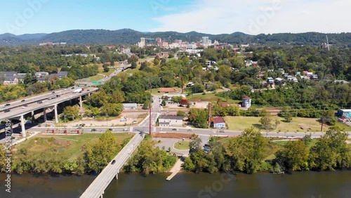 4K Drone Video (dolly shot) of French Broad River next to Downtown Asheville, NC viewed from the Westgate Area on Sunny Summer Day - 09 photo