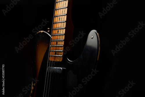 Old guitar with black background photo