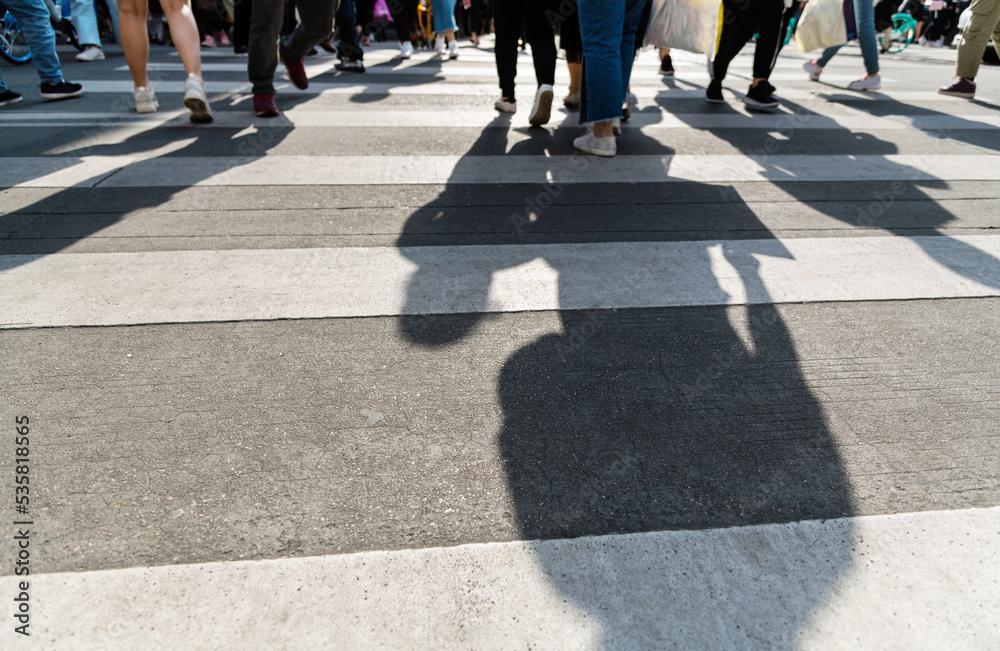 Shadows of people on the crosswalk Shadows of people on the crosswalk