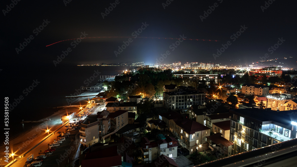 view of the outskirts of Adler and Sochi with the sea coast in night