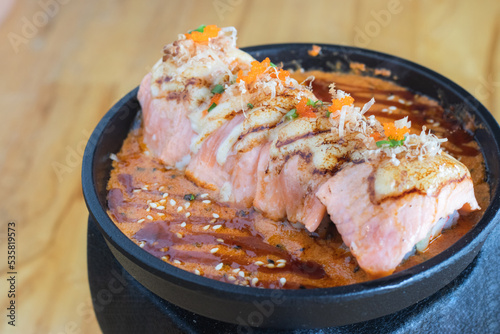 Grilled Salmon sushi with cream salad and spicy sauce placed on a Japanese grill, sushi is a traditional and popular food for Japanese people.