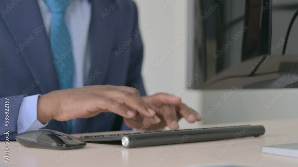 Close Up of Young African Businessman Working on Computer, Typing Close Up of Young African Businessman Working on Computer, Typing