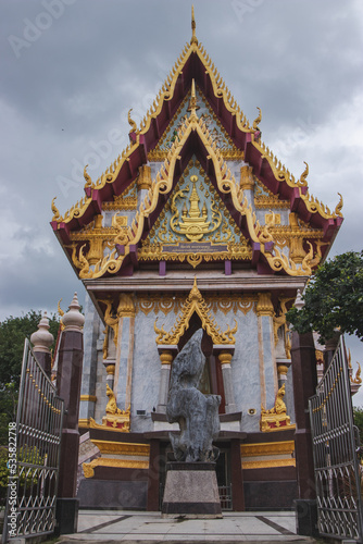 Golden pagoda in Northeastern of Thailand, Pagoda is on rainy cloud background. © kannapon