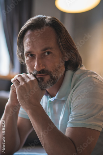 Mature bearded man sitting with a thoughtful look