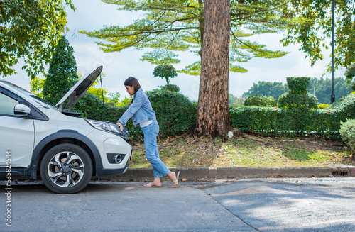 Photography Angry Asian woman and using mobile phone calling for assistance after a car breakdown on street