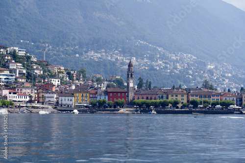 Beautiful view of village Ascona, Canton Ticino, on a sunny summer day with Lago Maggiore in the foreground. Photo taken July 25, 2022, Ascona, Switzerland. © Michael Derrer Fuchs