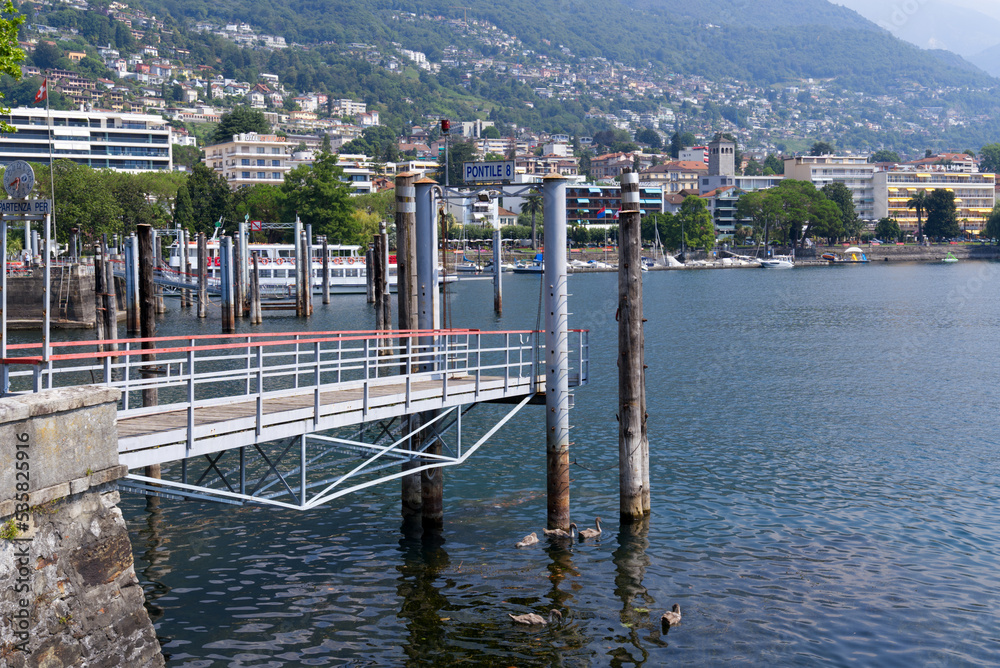 Pier 8 at border of Lake Lago Maggiore at City of Locarno, Canton Ticino, on a sunny summer day. Photo taken July 25th, 2022, Locarno, Switzerland.