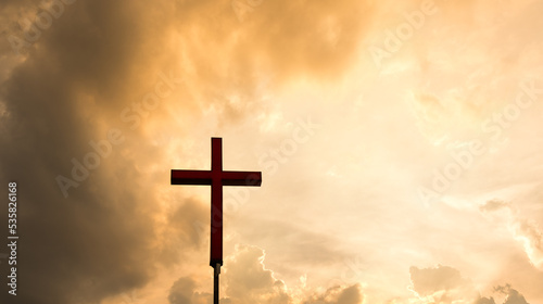 A cross under the sunset sky