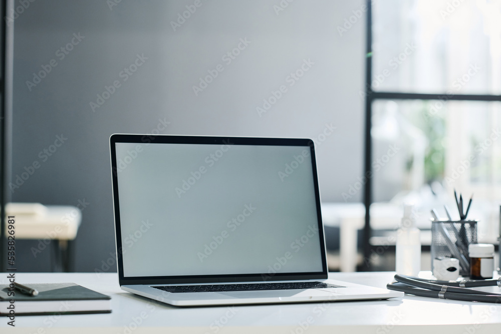 Fototapeta premium Close-up of laptop with empty screen on table for online work at office