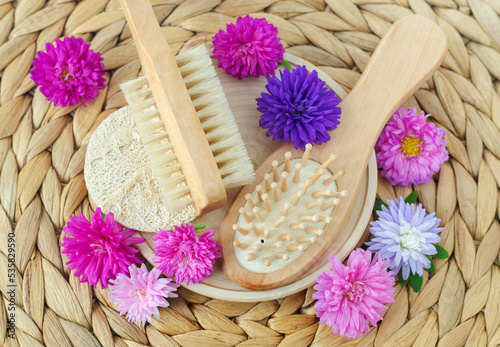 Wooden hair brush and massage body brush. Eco friendly toiletries. Natural beauty treatment, hair care or zero waste concept. Top view, copy space.