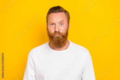 Portrait photo of young funny face grimace red hair man eyebrow up suspicious look you worker fail isolated on yellow color background