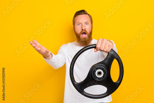 Photo unsatisfied furious person guy hand arm hold wheel yell scream whf negative reaction isolated on yellow color background photo