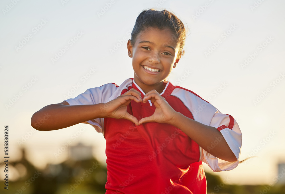 Heart hand and girl portrait at soccer game with passionate and happy