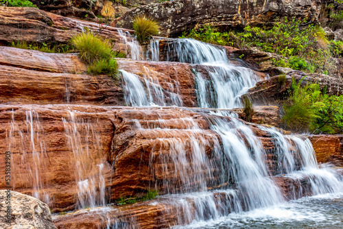 Water blur on beautiful and small waterfall among the rocks and vegetation of the Biribiri environmental reserve in Diamantina, Minas Gerais.