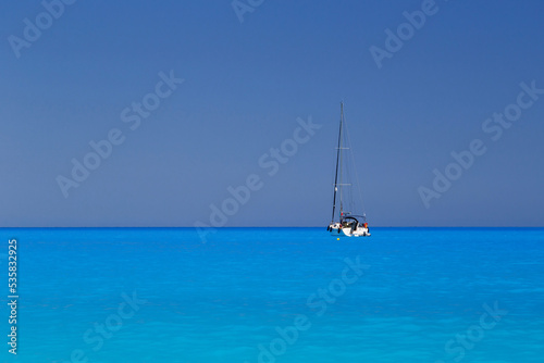 White yacht anchored in fantastic Myrtos Beach turquoise and blue bay. Summer scenery of famous and extremely popular travel destination in Cephalonia island, Greece, Europe © Iryna Budanova