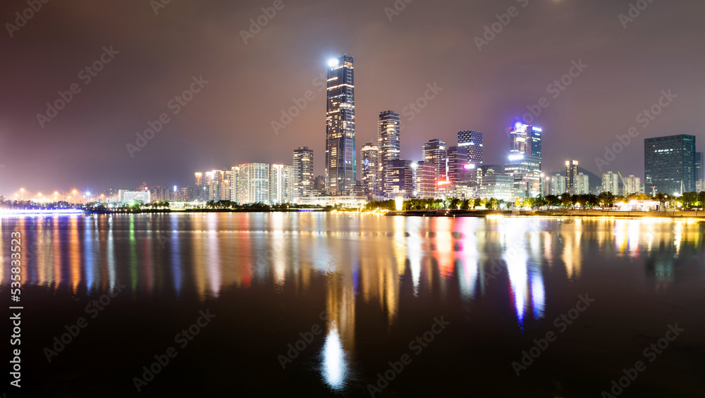 Fototapeta premium Office building reflected in the water at night