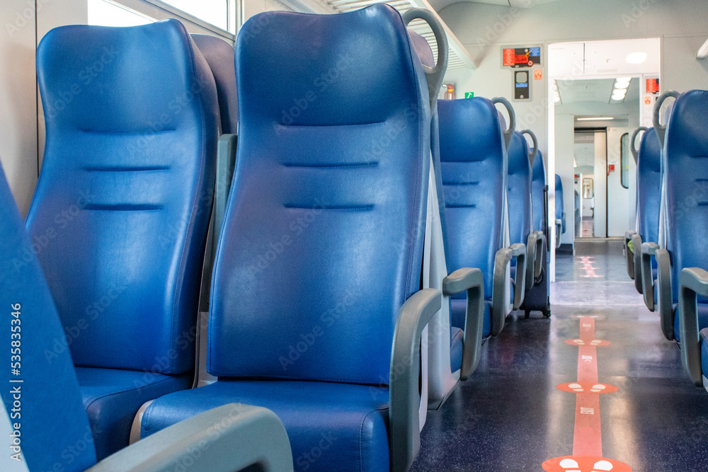 The interior of the car without people commuter train with seats. An