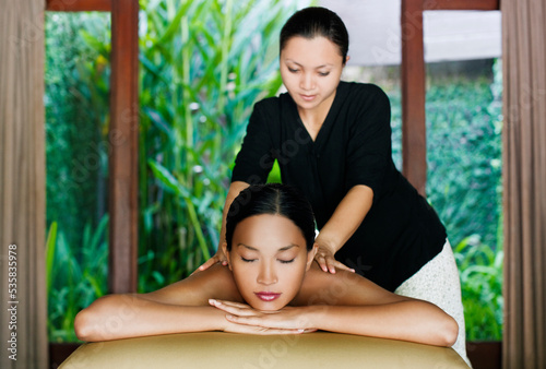 Woman receiving oil massage at a spa, Bali, Indonesia. photo
