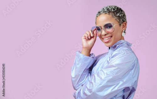 Fashion, sunglasses and black woman in vaporwave jacket on pink background in studio mock up space advertising and marketing. Gen z girl or young model with retro or vintage style portrait mockup